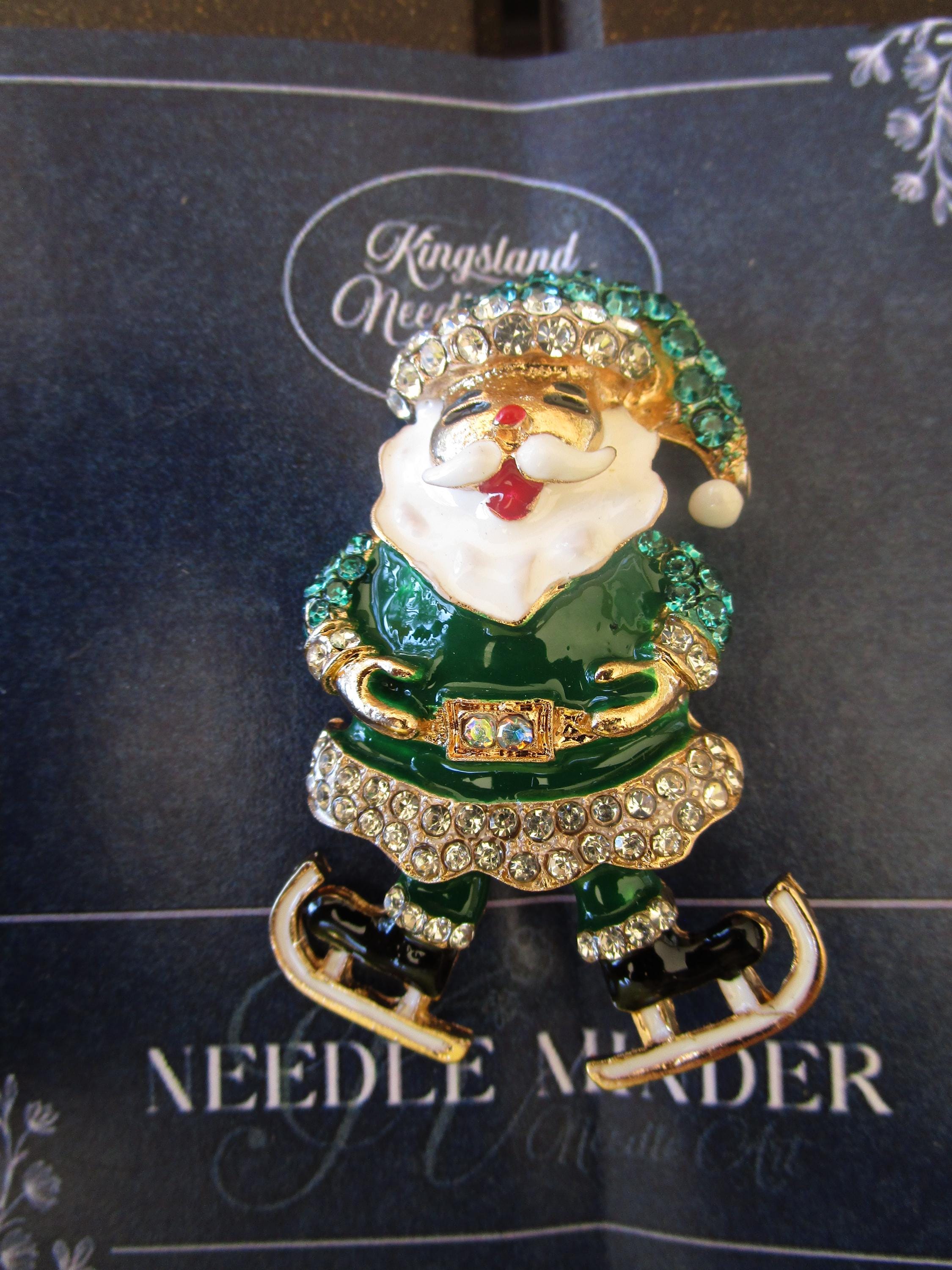 KINGSLAND NEEDLE MINDER ~ Skating Green Santa Family Needle Minder, Needle Dock, Swarovski Crystal Enamel Magnet, Needleminder
